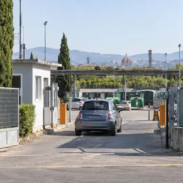 Ingresso di un centro comunale di raccolta con un’automobile che si avvicina ai contenitori