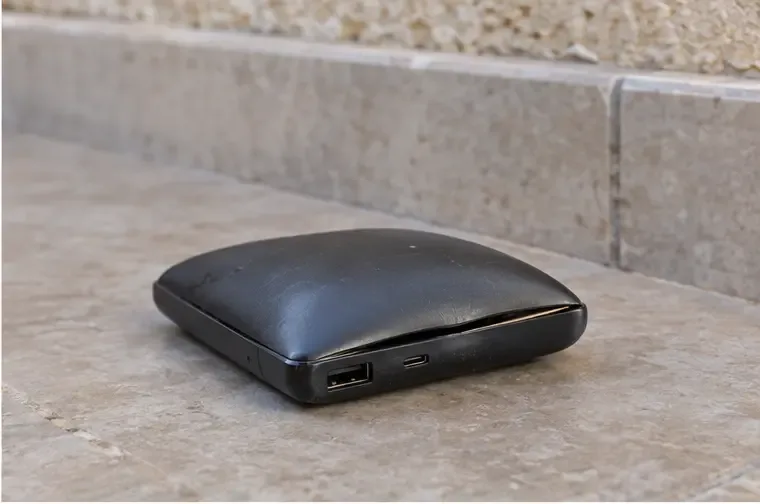 Dettaglio di una power bank nera con la custodia sollevata lungo la giunzione
