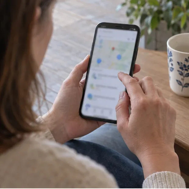 Personne consultant sur un smartphone une carte floutée de points de collecte
