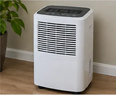 A reassembled white dehumidifier standing upright and ready to run after filter cleaning