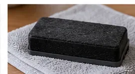 A cleaned dry-erase eraser resting on a folded towel to air dry