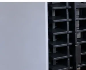Close-up of black ventilation openings along the rear edge of a white PS5 console.