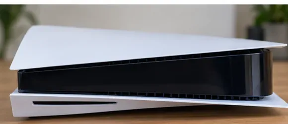 A clean PS5 console resting horizontally on an open tabletop after exterior cleaning.