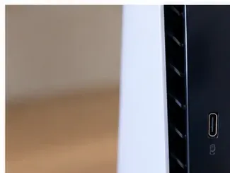 Close-up of a PS5 vent channel beside the black center section of the console.