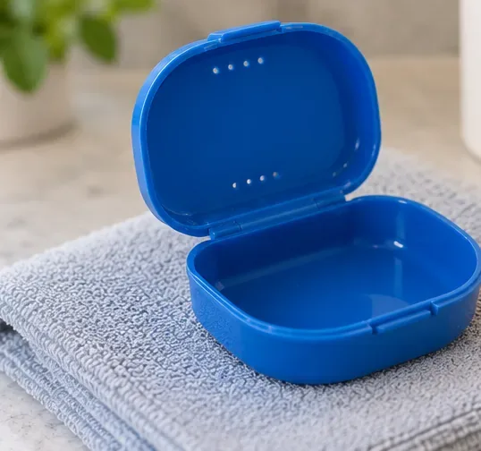 Clean open blue retainer case resting on a folded towel to air-dry