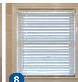 Clean white horizontal blinds reinstalled at a window after drying