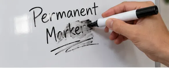 A hand drawing over permanent-marker writing with a fresh black dry-erase marker
