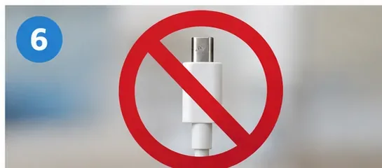 A charging plug shown behind a red prohibition symbol.
