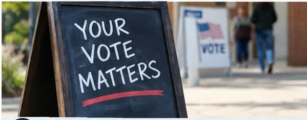A sidewalk sign reading Your Vote Matters outside a voting location