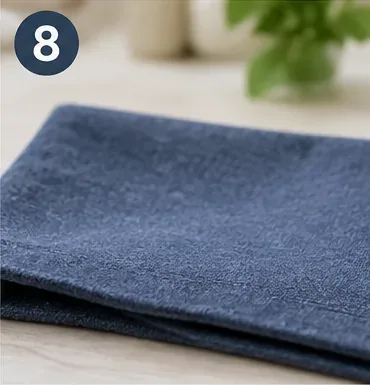 Folded blue fabric with an even clean surface after the glue-removal process