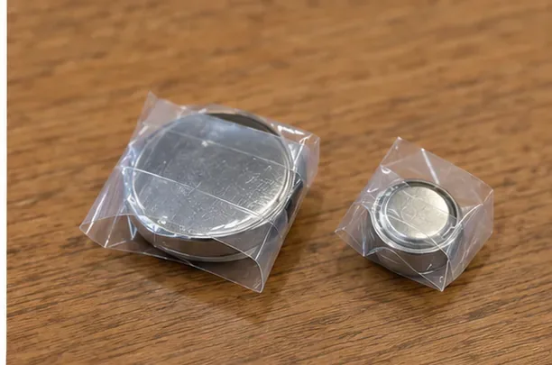 大小の丸形電池がそれぞれ透明なテープで包まれ、金属面が外部と直接触れない状態