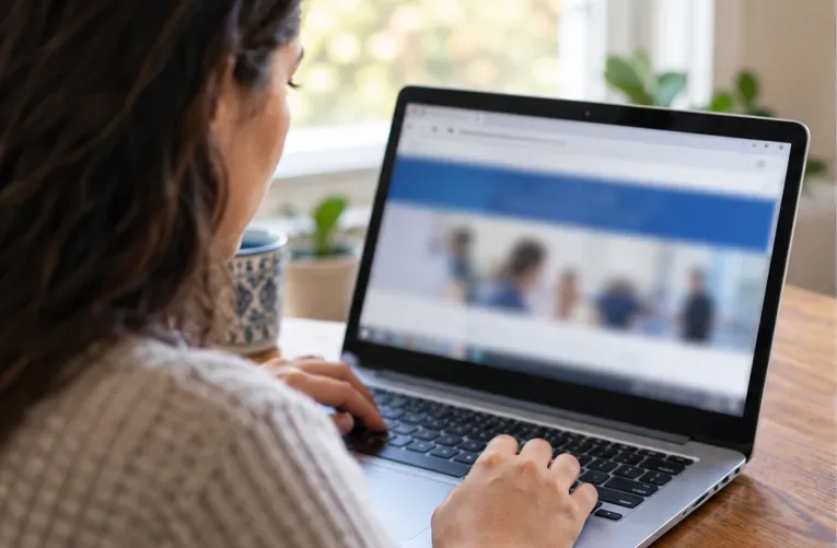 A consumer checks a settlement administrator website on a laptop at home.